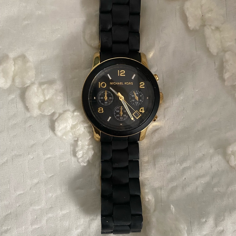 Michael Kors black silicone and gold finish watch.